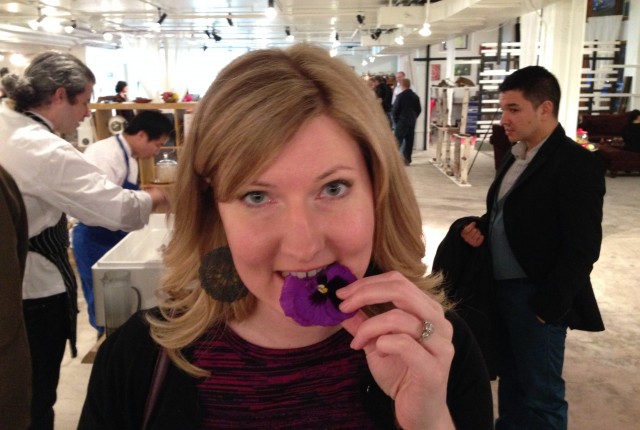 Kim tasting a purple pansy at the edible flower table